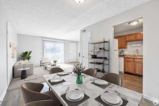 A dining room with a table set for four.
