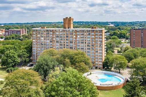 A large building with a pool in front of it.
