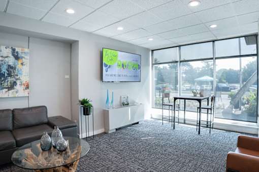 A conference room with a large screen displaying the word "eco" and a view of the outside.