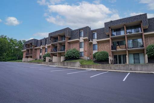 A parking lot in front of apartment buildings.