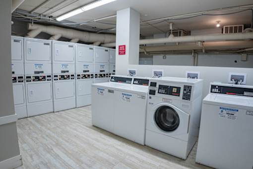 A row of washing machines in a laundromat.