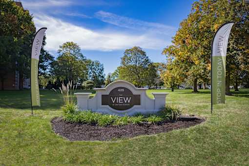 A sign that says "VIEW" is in the middle of a grassy area.