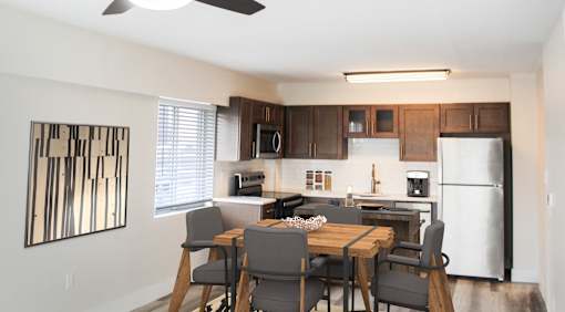 A modern kitchen with a dining table and chairs.