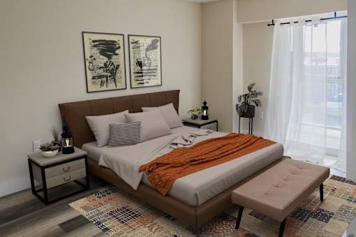 A bedroom with a large bed and two framed pictures on the wall.