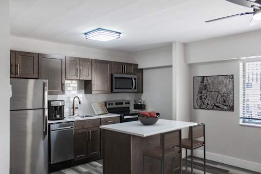 A modern kitchen with stainless steel appliances and wooden cabinets.