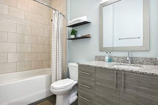 A bathroom with a toilet, sink, and shower.