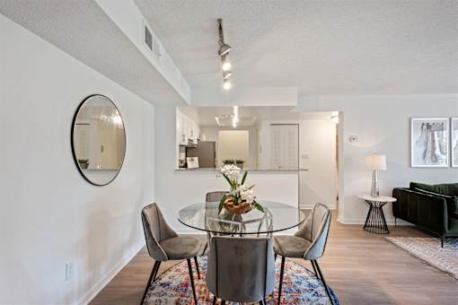 A dining room with a glass table and chairs.