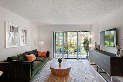 A living room with a green couch and a coffee table.