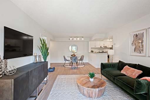 A living room with a green couch and a wooden coffee table.