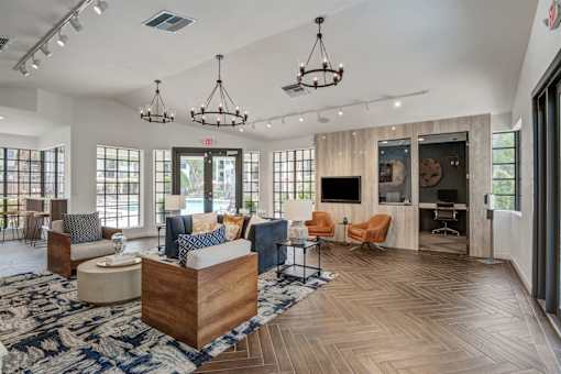 A spacious living room with a large wooden coffee table and multiple seating options.
