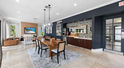 A modern dining room with a wooden table and chairs.