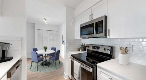 A modern kitchen with a table and chairs.