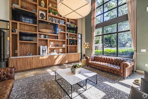 A modern living room with a coffee table, sofa, and a large window.