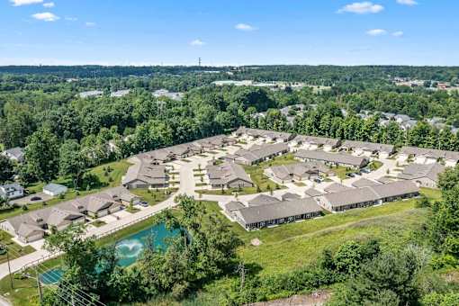 A bird's eye view of a residential area with houses and a swimming pool.