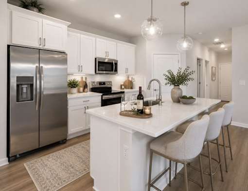 A modern kitchen with a large island and stainless steel appliances.