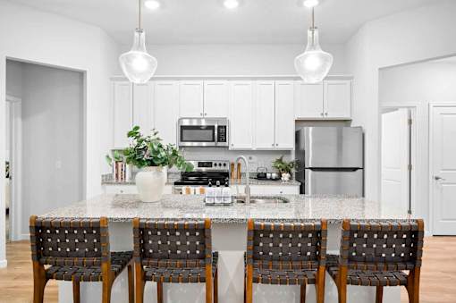 A kitchen with a granite countertop and a sink.