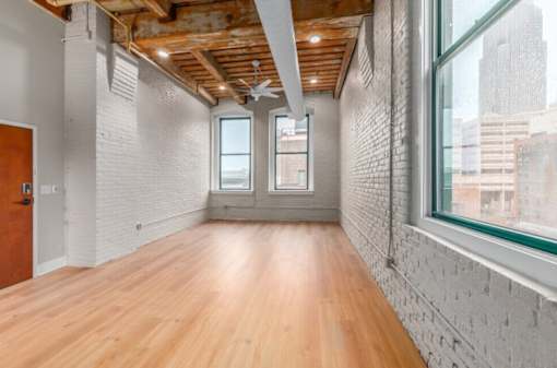 Room with white brick walls at Shorehaus Lofts Apartments, Cleveland
