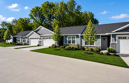 A row of houses with a driveway in front.