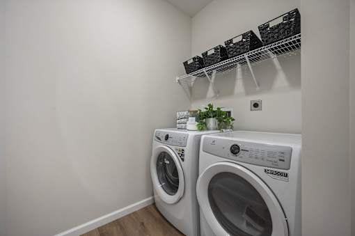 Two front load washing machines in a laundry room.