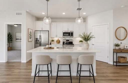 A modern kitchen with white cabinets and a central island.