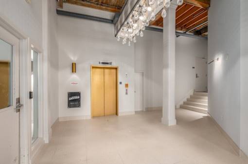 Hallway with a chandelier at Shorehaus Lofts Apartments, Cleveland, Ohio