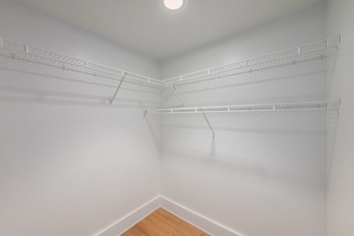 Empty white walk in closet at Shorehaus Lofts Apartments, Ohio, 44113