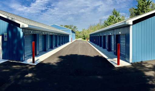 A long row of blue storage units with red posts at the end.
