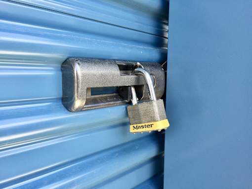 A padlock with the word "Master" on it is attached to a blue shutter.