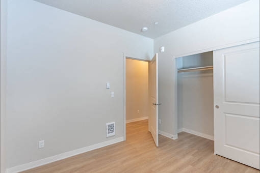 A room with a white door and a white wall.