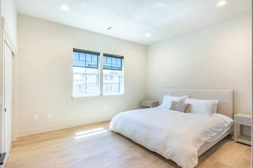 A bedroom with a large bed and a window.