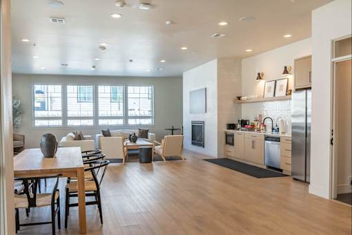 A modern kitchen with a dining table and chairs.