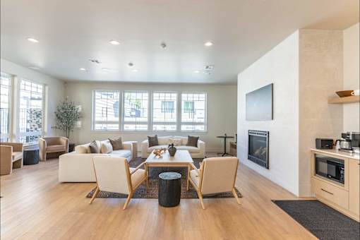 A modern living room with a fireplace and a television.