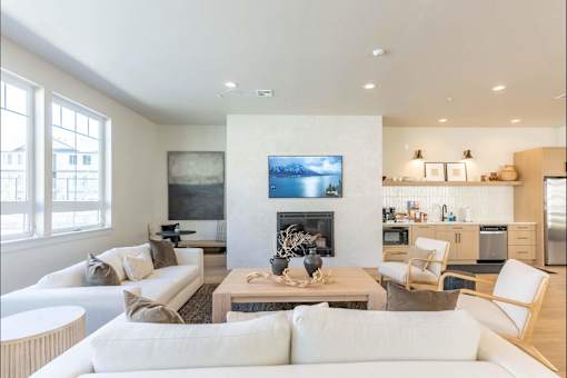 A modern living room with a fireplace and a painting on the wall.