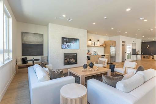 A modern living room with a fireplace and a television.
