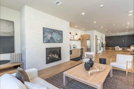 A living room with a fireplace and a painting on the wall.