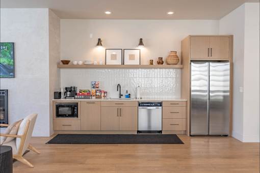 A modern kitchen with wooden cabinets and stainless steel appliances.