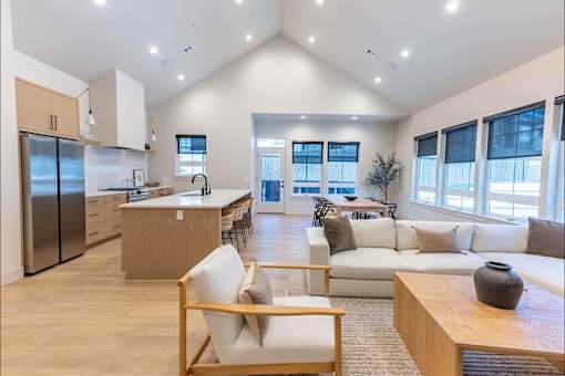 A modern kitchen with a refrigerator, sink, and cabinets.