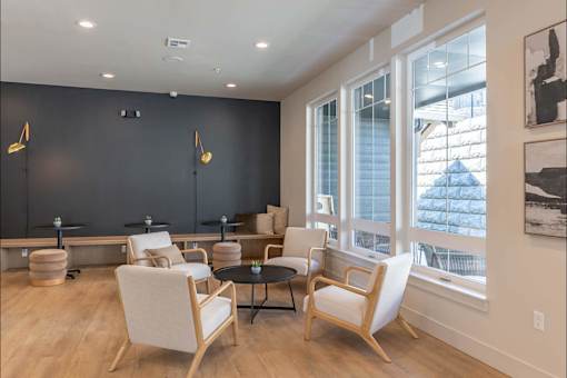 A room with a black wall and a table with chairs.