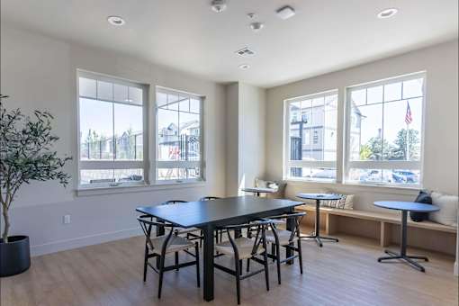 A dining room with a table and chairs.