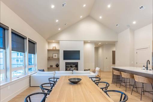 A modern dining room with a wooden table and chairs.