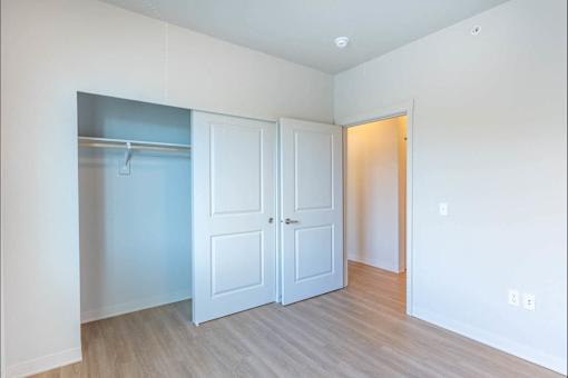 A room with a white door and a white wall.