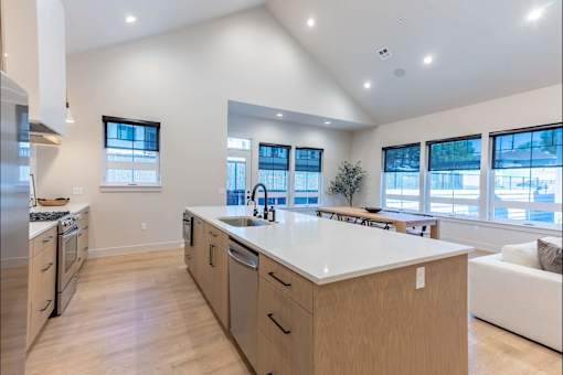 A modern kitchen with wooden cabinets and a large island.