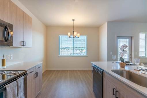 A kitchen with wooden cabinets and a stainless steel sink.