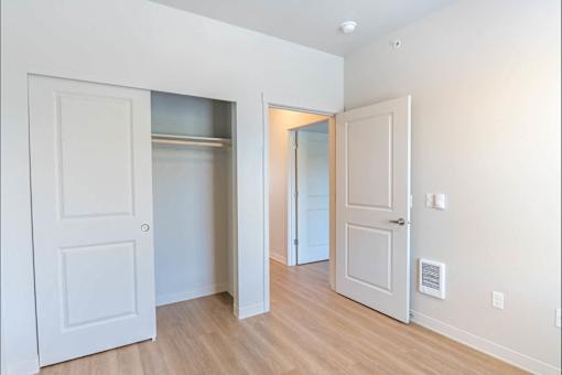A white door is open to a hallway.