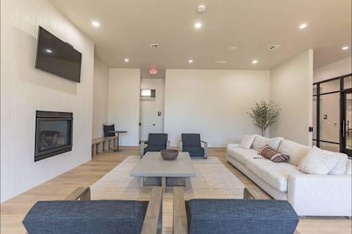 A modern living room with a fireplace and a white couch.
