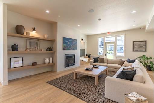 A living room with a fireplace and a couch at Cascade Place Apartment Homes, Oregon