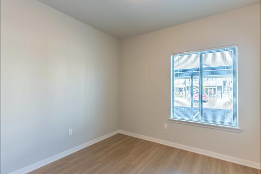 Empty room with a window overlooking a parking lot at Cascade Place Apartment Homes, Oregon, 97038