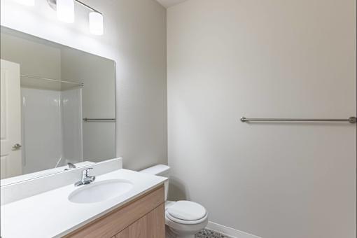 A white sink with a mirror above it in a bathroom at Cascade Place Apartment Homes, Molalla, OR, 97038