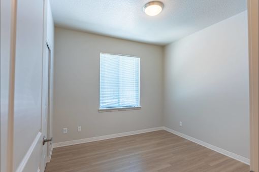 A room with a window and wooden flooring at Cascade Place Apartment Homes, Molalla, OR