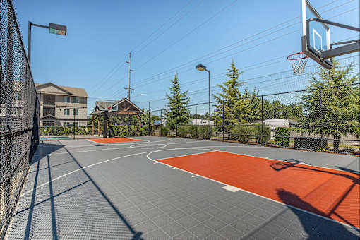 A basketball court with a basketball hoop and a backboard at Forestplace Apartment Homes, Oregon